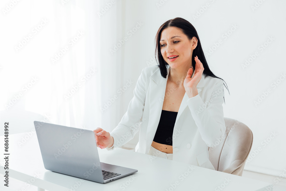 Brunette woman in business suit online working on the internet Brunette woman in business suit online working on the internet