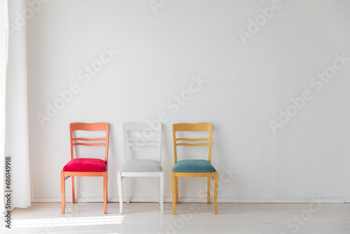 Fototapeta Naklejka Na Ścianę i Meble -  Three colorful vintage chairs in white room interior