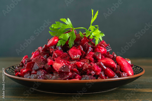 Lima Beans and Beetroot Salad served with fresh parsley on dark background. photo