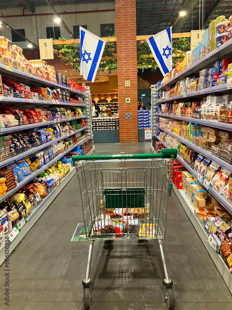 Israeli supermarket Tiv Tam. Empty grocery basket between the aisles of ...