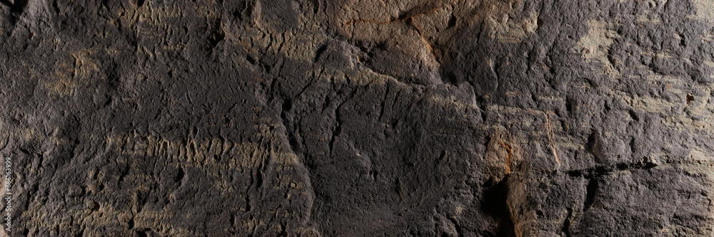 Brown stone texture, dark abstract background. Natural mineral rock close up details, empty backdrop with copy space for design