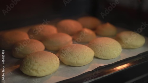 Time lapse baking choux cream (cream puffs) quickly puffs up in the pastry oven stock video, Making homemade dessert concept