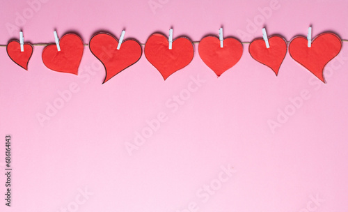 Red hearts border on pink background, diversity concept for Valentine day. Handmade, Paper craft.