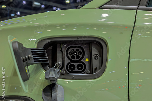Charge port on an electric car, Ev Charging Port on electric car. Electronic car charging devise publicly installed. EV charger or electronic vehicle charger..