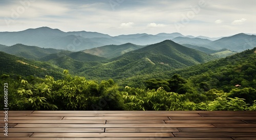 Expansive Wooden Deck Overlooking Layers of Lush Green Mountains Under a Hazy Sky photo