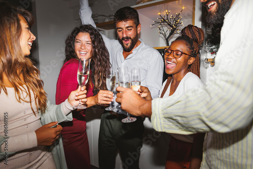 Friends drinking champagne and dancing at New Year party