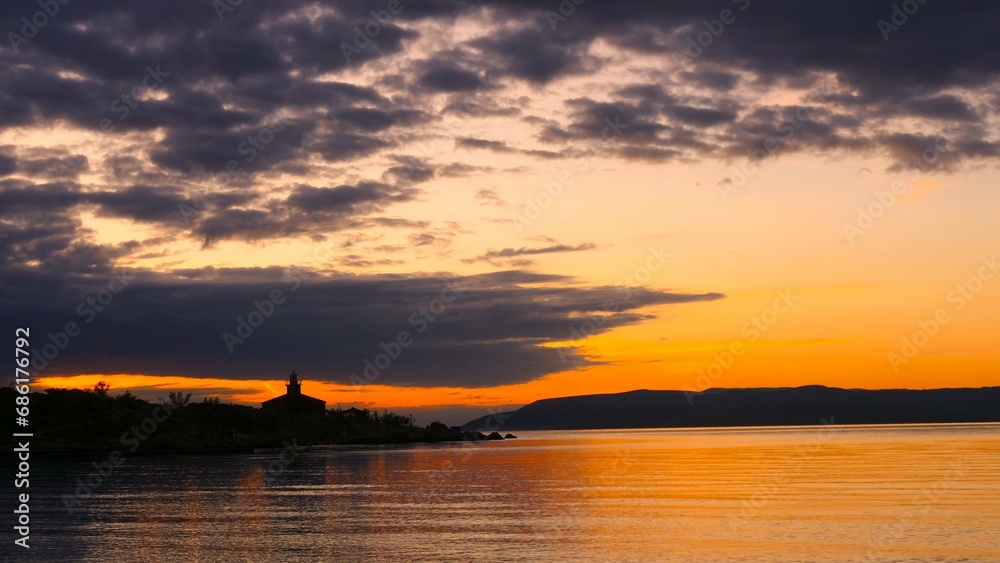 Lighthouse in beautiful orange sunset