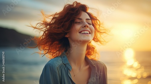 Portrait of calm happy smiling free woman with open arms and closed eyes enjoys a beautiful moment life on the seashore at sunset time #686181741