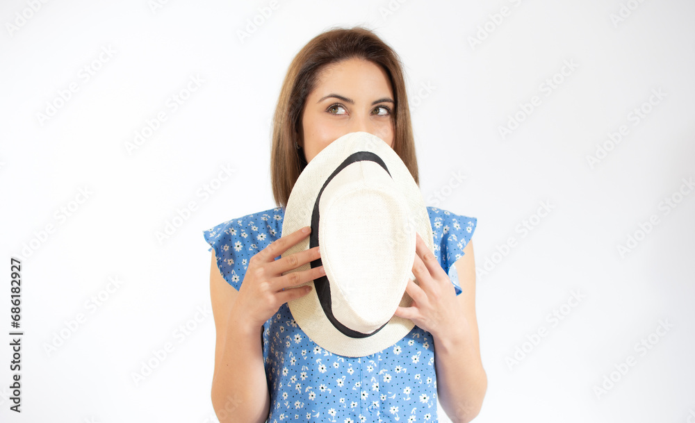 Portrait of excited smiling young woman holding straw summer hat in hands, copy space isolated on white background. People sincere emotions, lifestyle concept. Advertising area Portrait of excited smiling young woman holding straw summer hat in hands, copy space isolated on white background. People sincere emotions, lifestyle concept. Advertising area