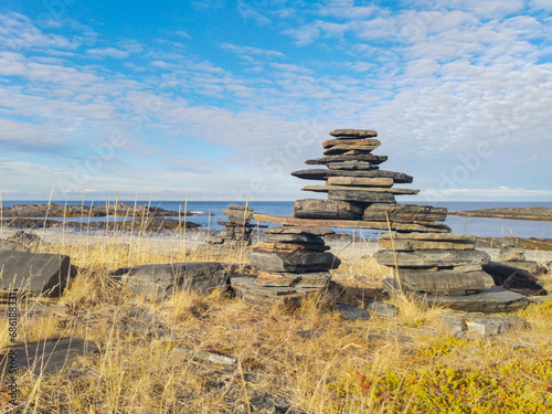 The rocky coast of the Barents Sea. Beautiful view of the rocks and the coast of the Rybachy and Sredny peninsulas, Murmansk region, Russia. The landscape is the harsh beauty of the north. photo