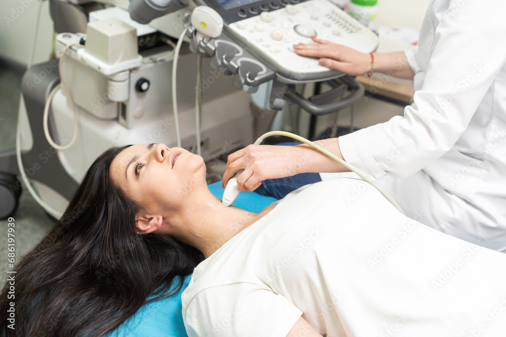 Qualified medical specialist using ultrasound equipment in the clinic Qualified medical specialist using ultrasound equipment in the clinic