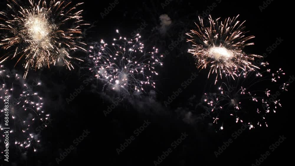 Bright colorful festive glowing fireworks on night sky.  New Year, Christmas, festival, party and holiday celebration concept