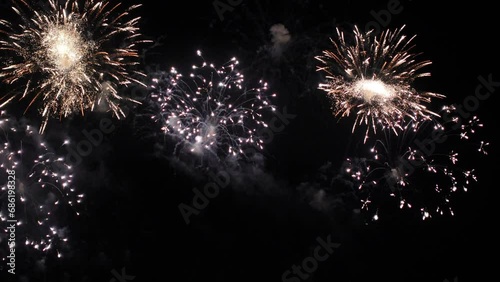 Bright colorful festive glowing fireworks on night sky.  New Year, Christmas, festival, party and holiday celebration concept