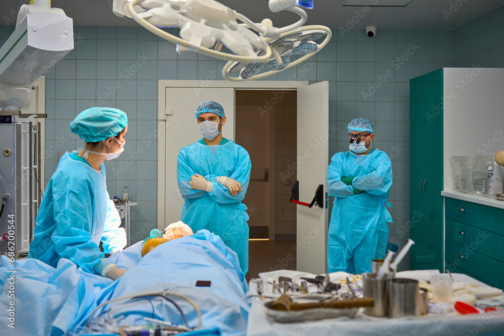team of surgeons operate on the patient team of surgeons operate on the patient