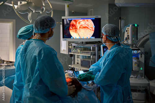 team of surgeons operate on the patient photo