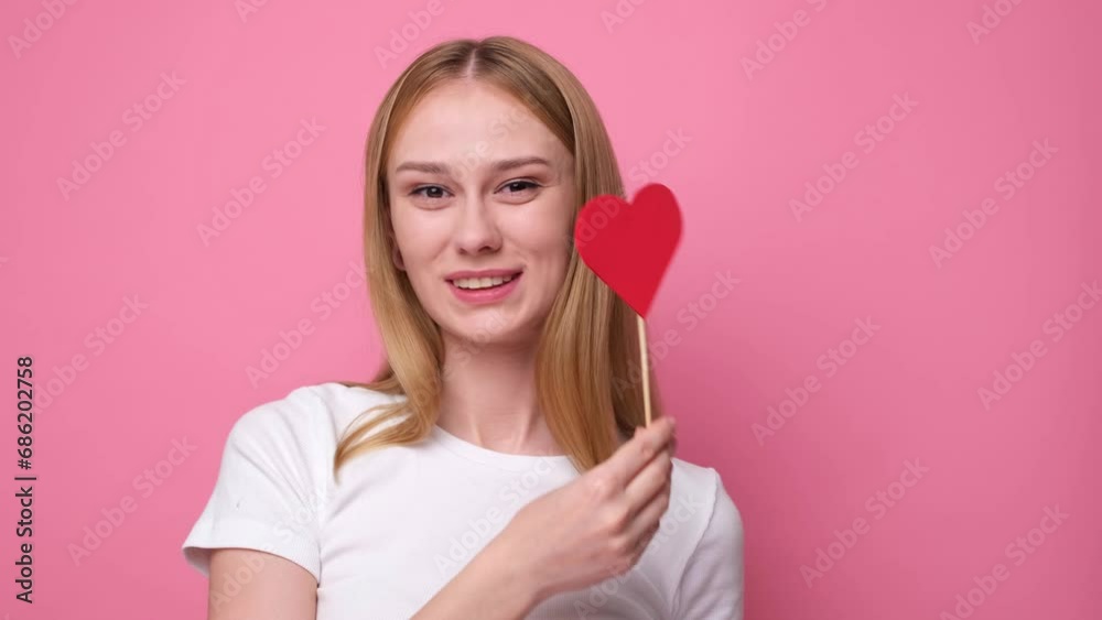 Portrait of attractive girl on pink background with red hearts for valentine's day. Concept of congratulations for holidays. Portrait of attractive girl on pink background with red hearts for valentine's day. Concept of congratulations for holidays.
