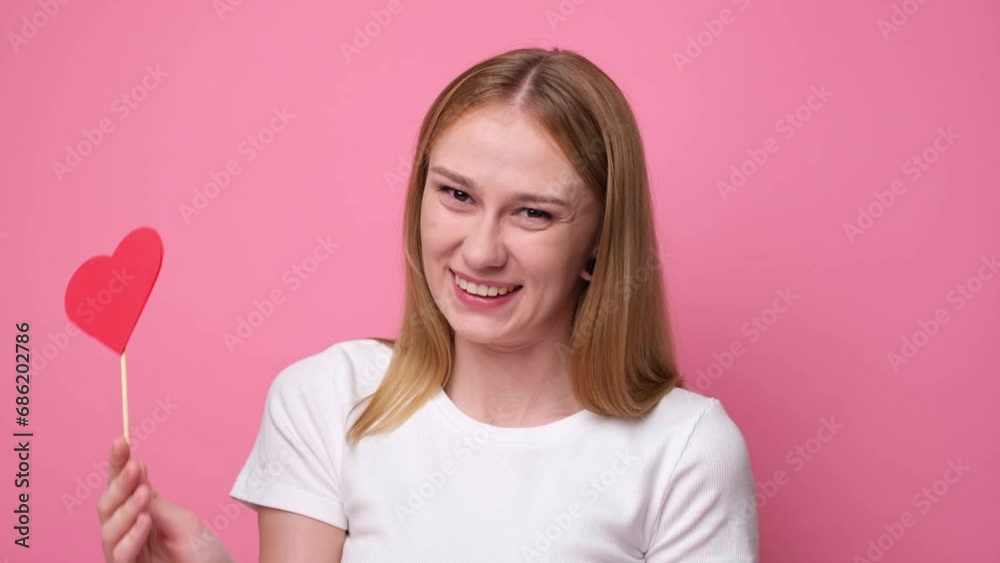 Portrait of attractive girl on pink background with red hearts for valentine's day. Concept of congratulations for holidays. Portrait of attractive girl on pink background with red hearts for valentine's day. Concept of congratulations for holidays.