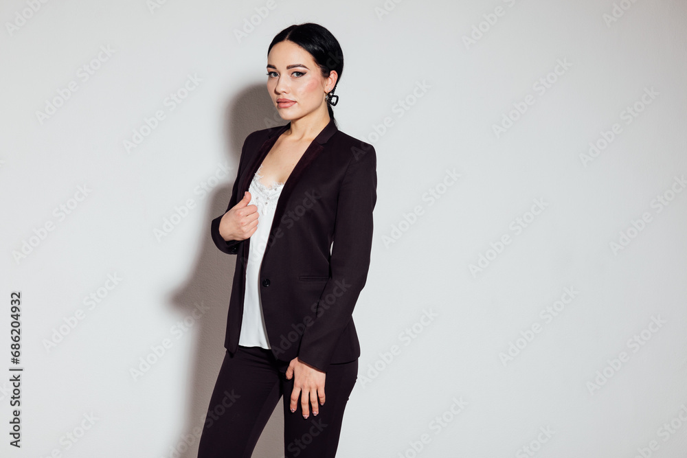 Business beautiful woman in brown business suit in office Business beautiful woman in brown business suit in office