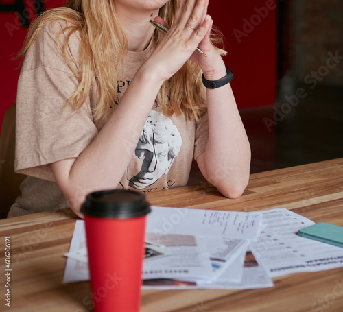 A young girl thinking about learning materials