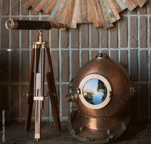 Still life retro diver's helmet and telescope tube