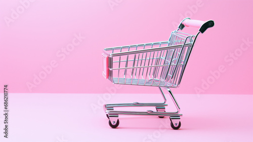 ピンクの背景にピンクのショッピングカートのミニチュア