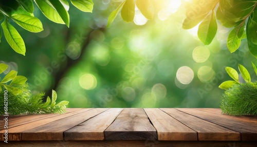 old wooden table top with defocused sunny green background