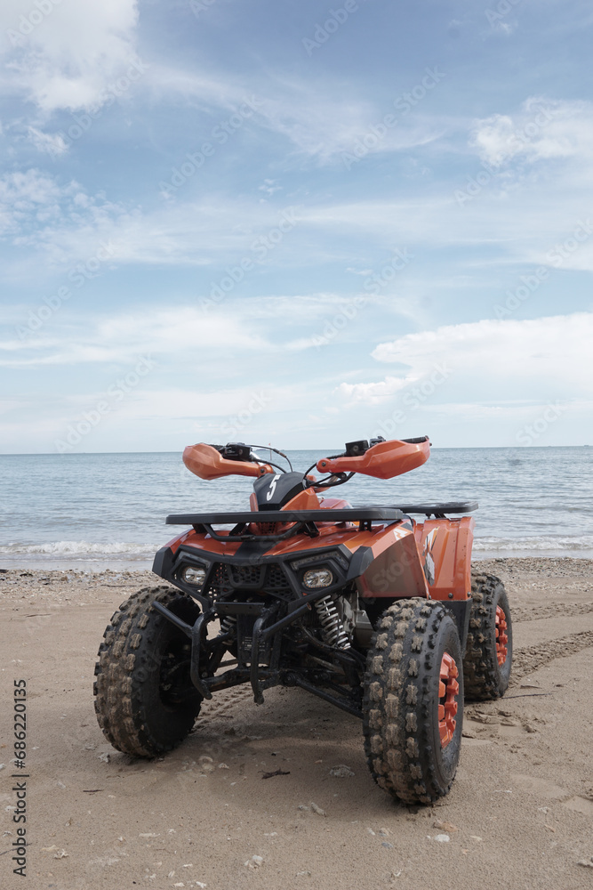 ATV Parked at seashore on clean beach with beautiful skies ATV Parked at seashore on clean beach with beautiful skies