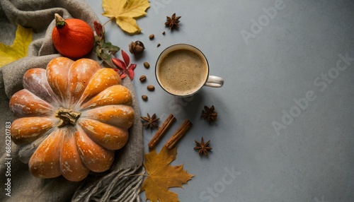 coziness of being at home in autumn above view photo of a cup of hot coffee patchy blanket pumpkin shaped candles maple foliage and aromatic spices on grey background with copy space