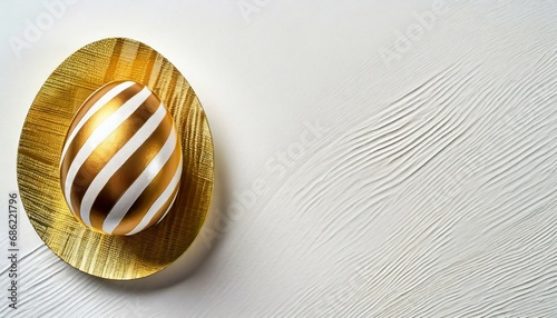 easter golden with striped patternd egg on white background minimal easter concept happy easter card with copy space for text top view flatlay concept for banner flyer invitation