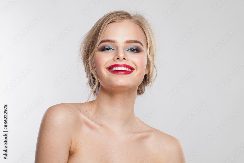 Excited young female model portrait. Blonde woman with long wavy hair, makeup and clean skin on white background Excited young female model portrait. Blonde woman with long wavy hair, makeup and clean skin on white background