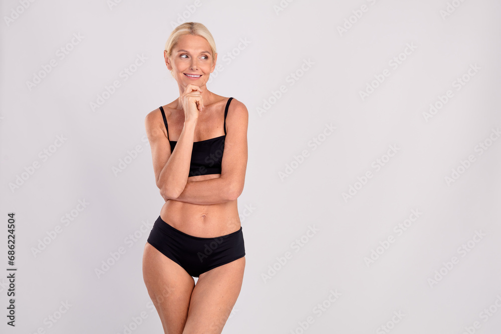Fototapeta premium Photo of stunning fitness lady hand touch chin loom empty space contemplate isolated on grey color background