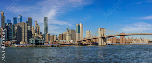 Panorama view of New York City featuring Manhattan midtown business district office buildings near Brooklyn Bridge USA