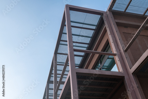 construction detail of building with gallery and steel structure, fall protection nets instead of handrails. modern school with facade, steel frame building, school complex, campus
