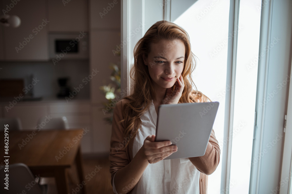Gorgeous young woman using tablet in living room Gorgeous young woman using tablet in living room