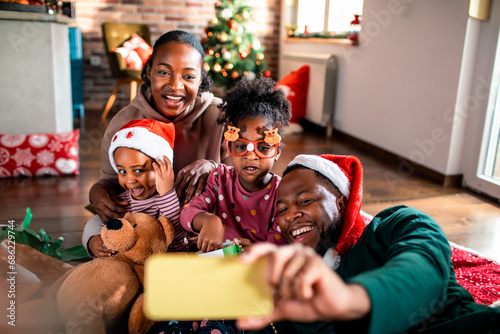 Family taking selfie at home during christmas holidays photo