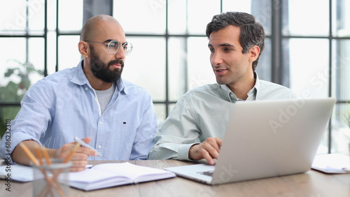 Businessman working on the table with laptop in a new office