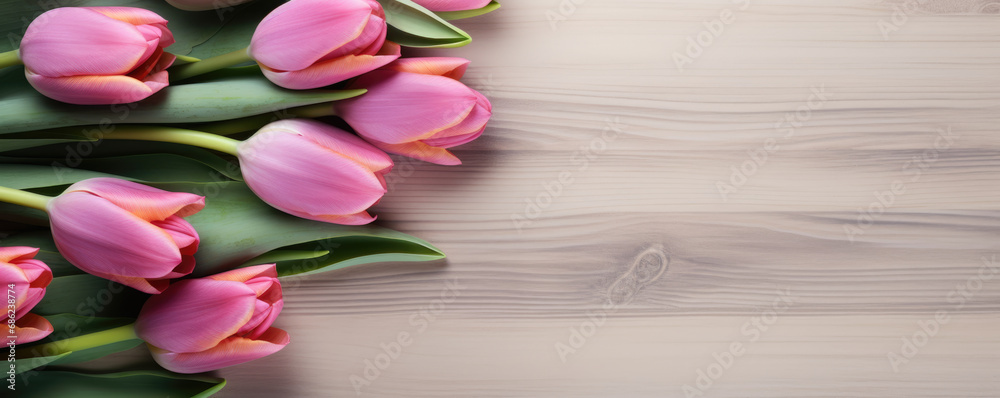 Beautiful pink tulips on a wooden table with copy space for text at the bottom. Spring background. Beautiful pink tulips on a wooden table with copy space for text at the bottom. Spring background.