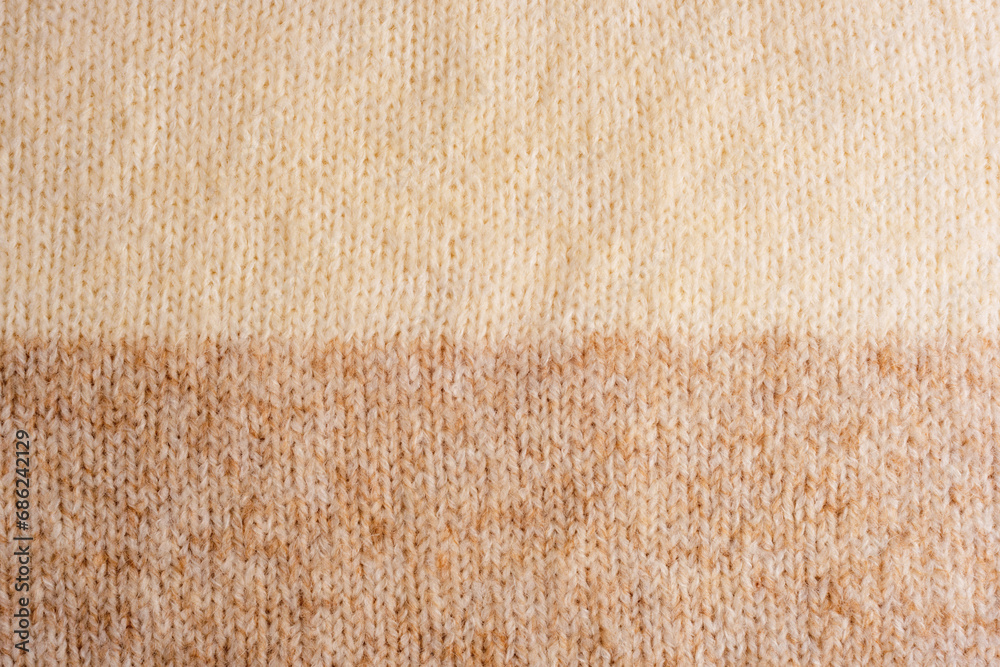 Beige and brown woolen knitted sweater fabric, texture, background - obrazy, fototapety, plakaty 