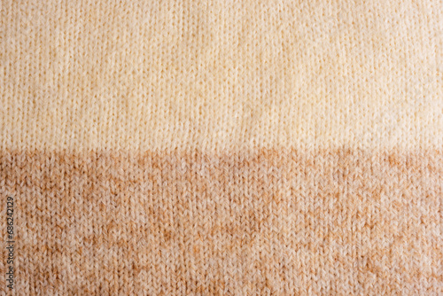 Beige and brown woolen knitted sweater fabric, texture, background photo