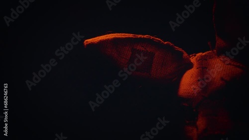 Soldier in a scary mask. A scary rabbit mask illuminated by a blinking light in a dark forest.
