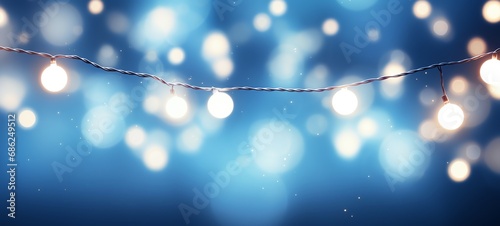 Christmas holiday and Happy New Year decoration and illumination concept. Garland bokeh lights over blue background.
