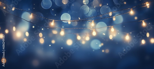 Christmas holiday and Happy New Year decoration and illumination concept. Garland bokeh lights over blue background.