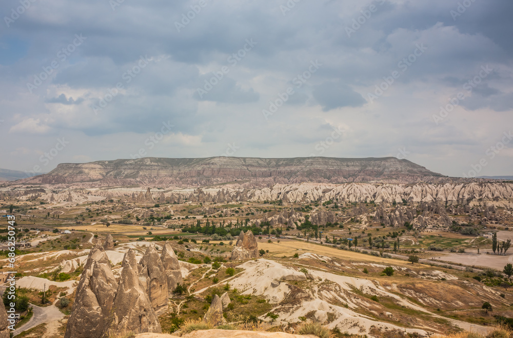Rocky landscape in Cappadocia, Turkey. Travel in Cappadocia. Unusual semi-desert mountain ranges. Amazing Rocky summer landscape in Cappadocia Goreme Rocky landscape in Cappadocia, Turkey. Travel in Cappadocia. Unusual semi-desert mountain ranges. Amazing Rocky summer landscape in Cappadocia Goreme