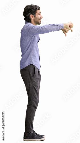 young man in full growth. isolated on white background showing bad sign with thumb