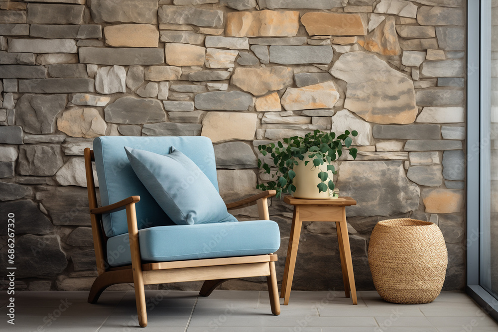 Relaxing in Style on a Cozy Blue Armchair Against an Empty Stone Wall. Nostalgic Vibes and Tranquility in Vintage Interior Design. Inviting Corner for Leisure and Contemplation