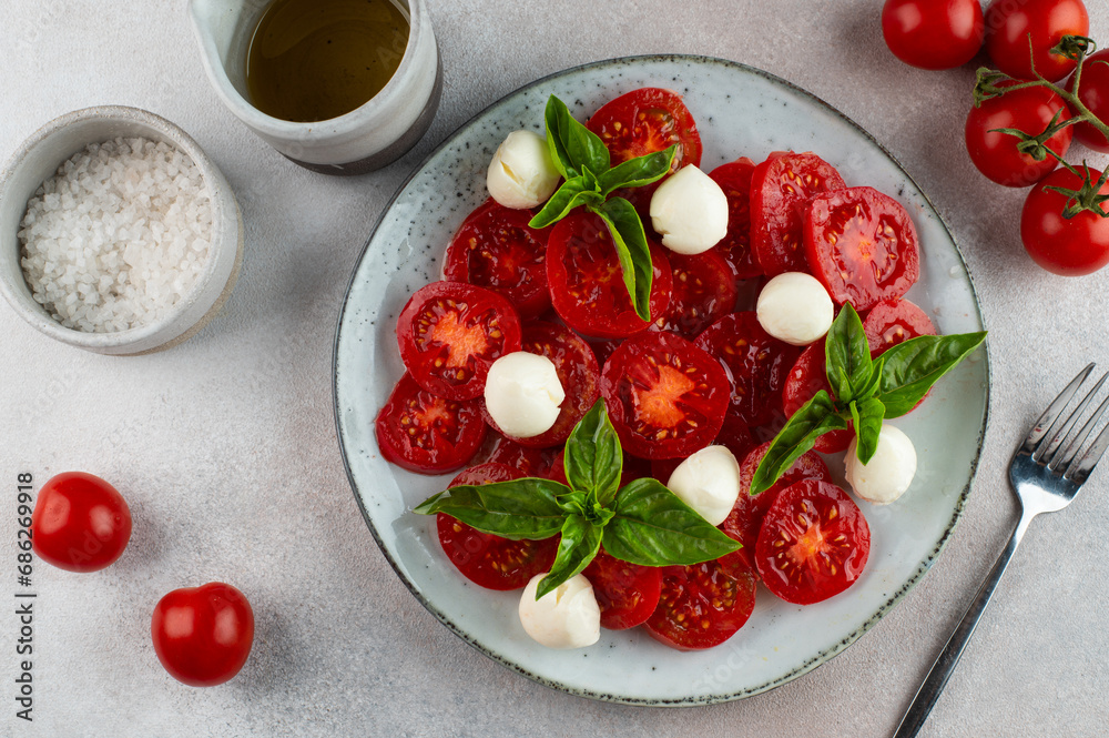 Caprese salad with tomato, basil and mozzarella. Italian salad. Italian food. Caprese salad with tomato, basil and mozzarella. Italian salad. Italian food.