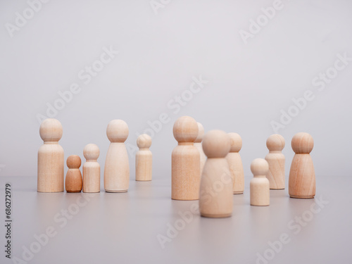 Wooden figures. A group of people standing together at a table. Communication concept.