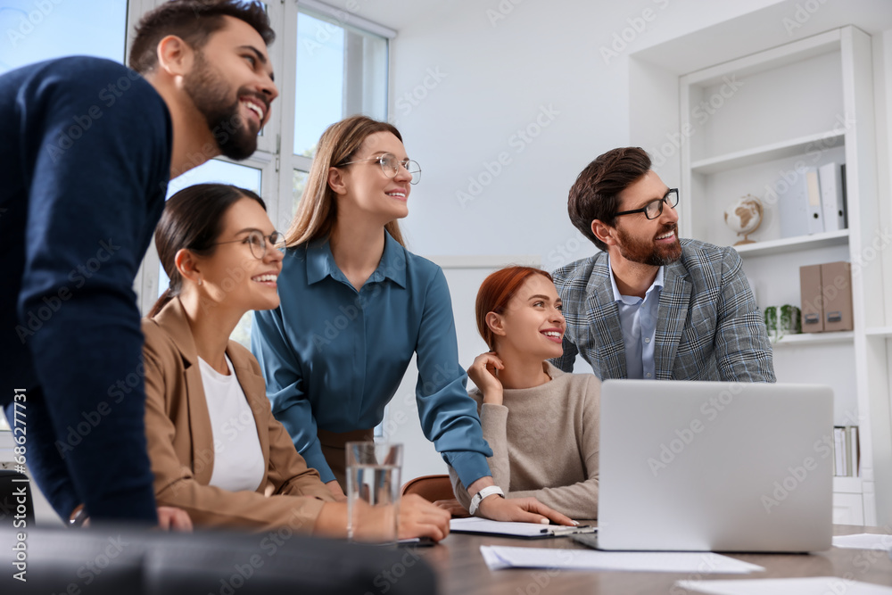 Team of employees working together in office Team of employees working together in office