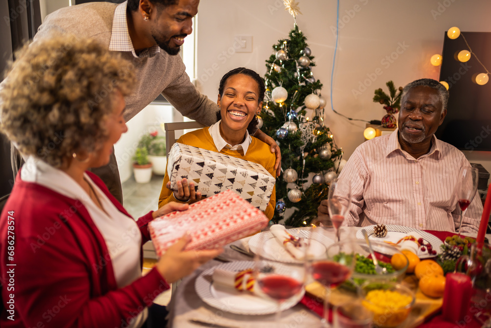 Giving gifts to the grandparents on Christmas dinner. Giving gifts to the grandparents on Christmas dinner.