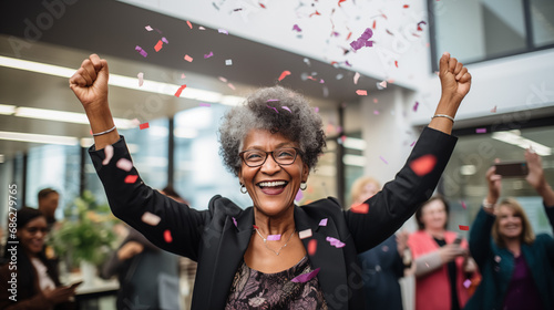 An woman celebrates the last day of work in office before the retirement.